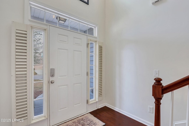 entryway with dark wood-style floors and baseboards