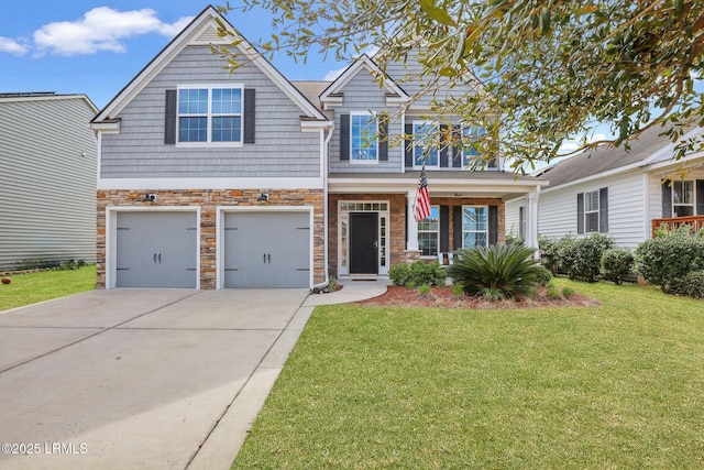 view of front of property with driveway, a garage, stone siding, a porch, and a front yard