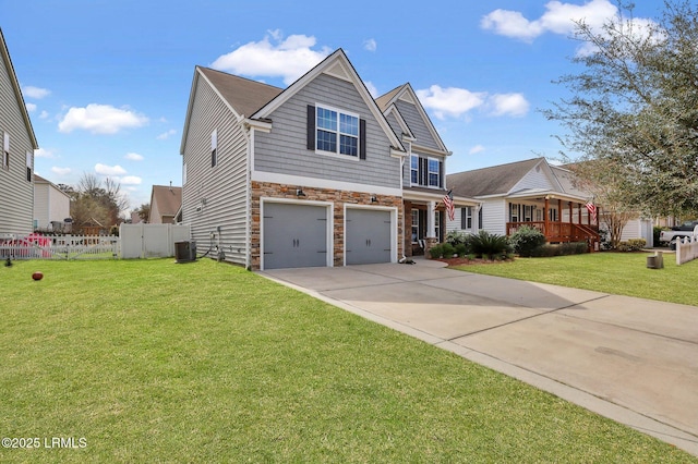 view of front of home with central air condition unit, a front yard, fence, stone siding, and driveway