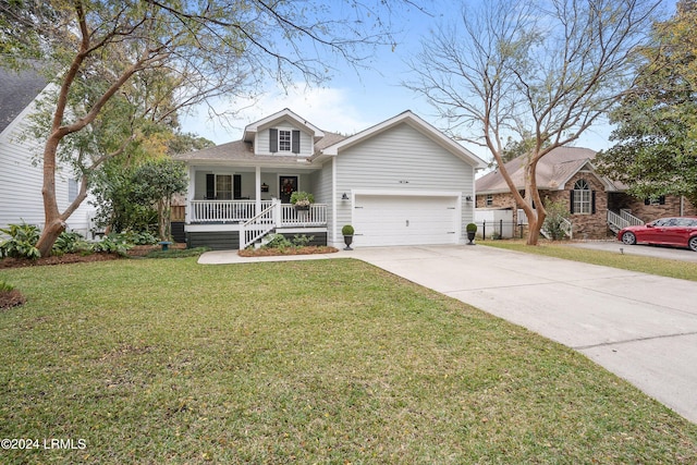 view of front of house featuring a garage, a front lawn, and covered porch