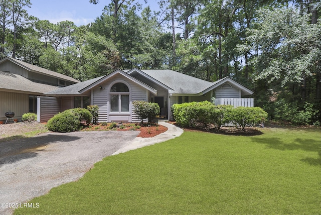 7 Stillwater Ct, Hilton Head Island, SC 29926 - single story home with a front lawn, view of wooded area, and a shingled roof