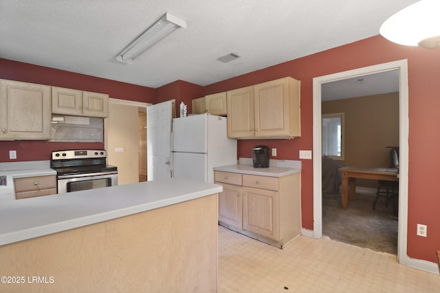 7 Stillwater Ct, Hilton Head Island, SC 29926 - kitchen featuring electric range, freestanding refrigerator, light brown cabinetry, light countertops, and light flooring