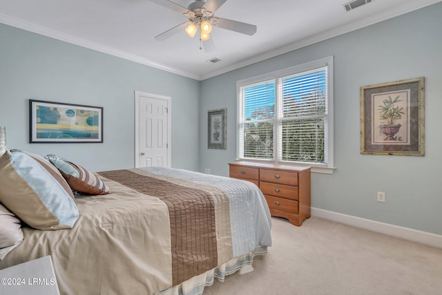 carpeted bedroom with ornamental molding and ceiling fan