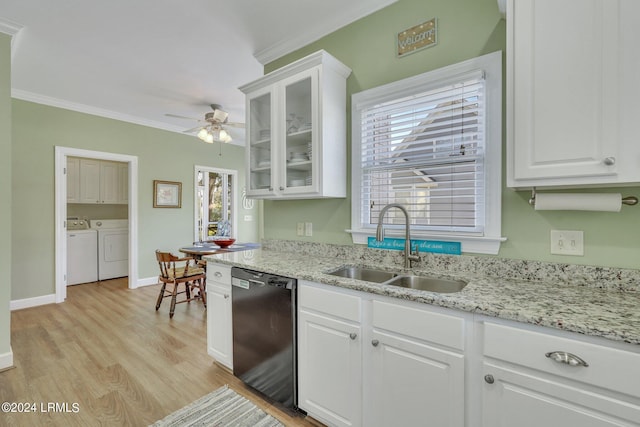 kitchen featuring white cabinetry, separate washer and dryer, black dishwasher, and sink