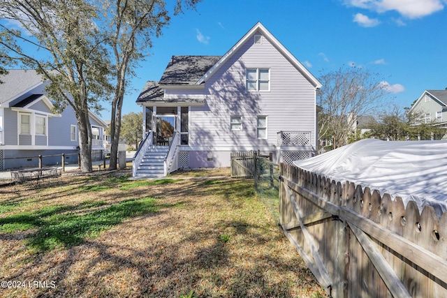 back of house featuring a yard