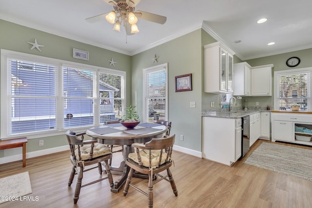 dining room featuring ceiling fan, ornamental molding, sink, and light hardwood / wood-style flooring