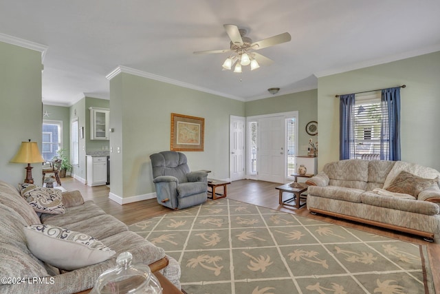 living room with crown molding, ceiling fan, and wood-type flooring