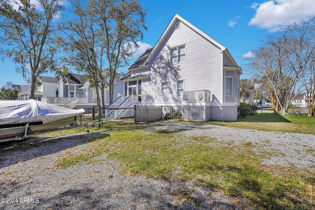 view of side of property with a yard