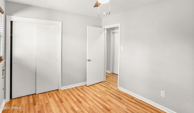 unfurnished bedroom with ceiling fan, light hardwood / wood-style floors, and a closet