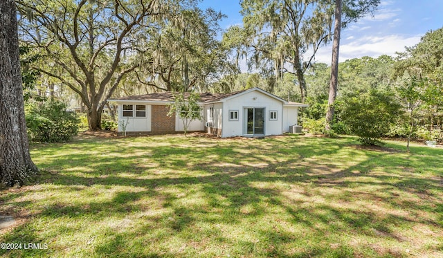 exterior space featuring cooling unit and a lawn