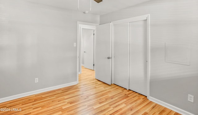 unfurnished bedroom with ceiling fan, light hardwood / wood-style floors, and a closet