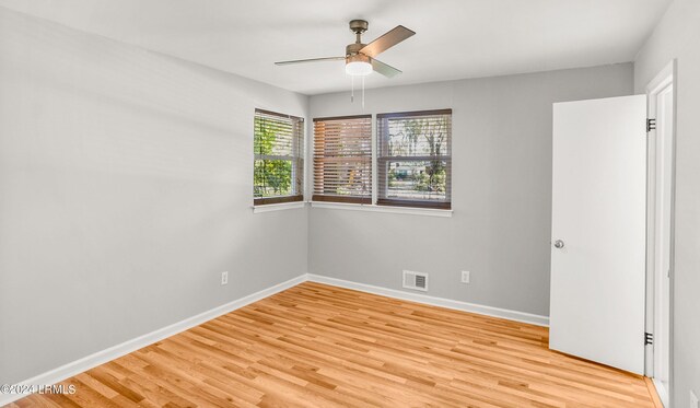 empty room featuring ceiling fan and light hardwood / wood-style floors