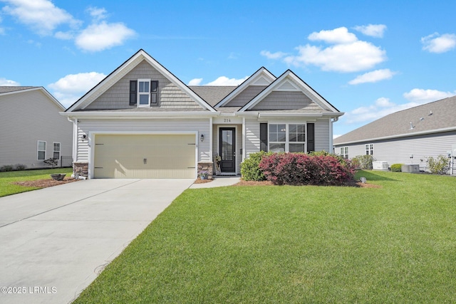 214 Lombards Mill Ln, Okatie, SC 29909 - craftsman house featuring cooling unit, concrete driveway, stone siding, a front yard, and a garage