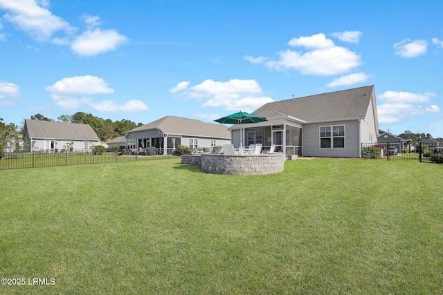 214 Lombards Mill Ln, Okatie, SC 29909 - rear view of house featuring a fenced backyard, a sunroom, a shingled roof, and a lawn