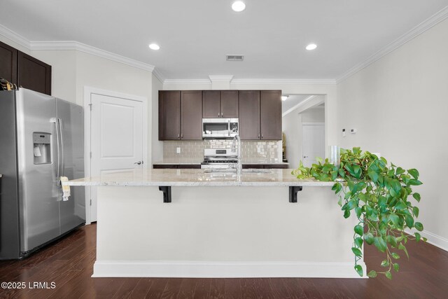 214 Lombards Mill Ln, Okatie, SC 29909 - kitchen featuring a breakfast bar, dark wood-style flooring, stainless steel appliances, and dark brown cabinets