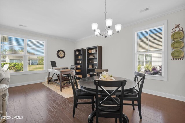 214 Lombards Mill Ln, Okatie, SC 29909 - dining space with dark wood finished floors, baseboards, visible vents, ornamental molding, and an inviting chandelier