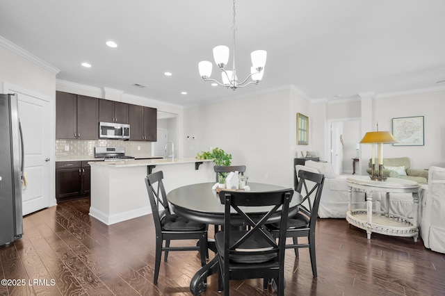 214 Lombards Mill Ln, Okatie, SC 29909 - dining area featuring recessed lighting, an inviting chandelier, ornamental molding, and dark wood-style flooring