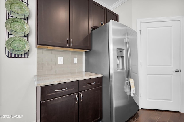 214 Lombards Mill Ln, Okatie, SC 29909 - kitchen with crown molding, light stone countertops, tasteful backsplash, dark brown cabinetry, and stainless steel fridge with ice dispenser