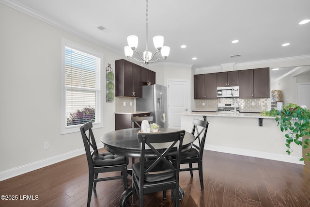214 Lombards Mill Ln, Okatie, SC 29909 - dining area featuring dark wood finished floors, crown molding, a chandelier, and visible vents