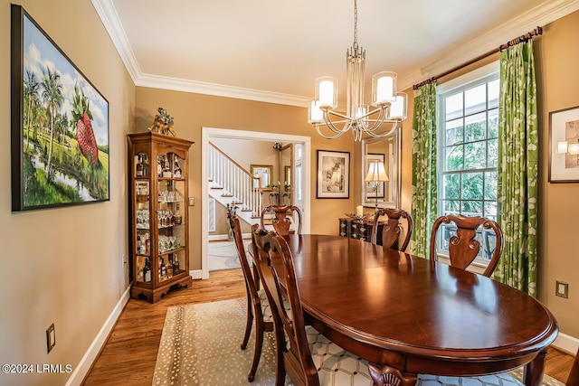 dining room featuring ornamental molding, a chandelier, and hardwood / wood-style floors