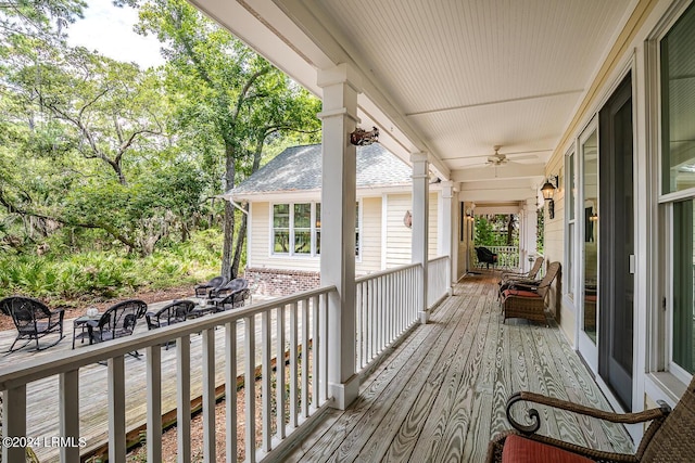 wooden deck featuring ceiling fan and a porch