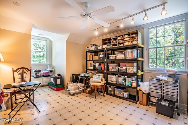 living area with lofted ceiling, ceiling fan, and a healthy amount of sunlight