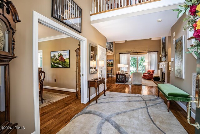 foyer featuring crown molding and wood-type flooring