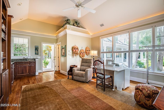 interior space with ceiling fan, ornamental molding, vaulted ceiling, and hardwood / wood-style floors