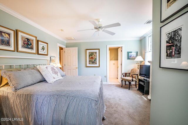 carpeted bedroom featuring ceiling fan and ornamental molding