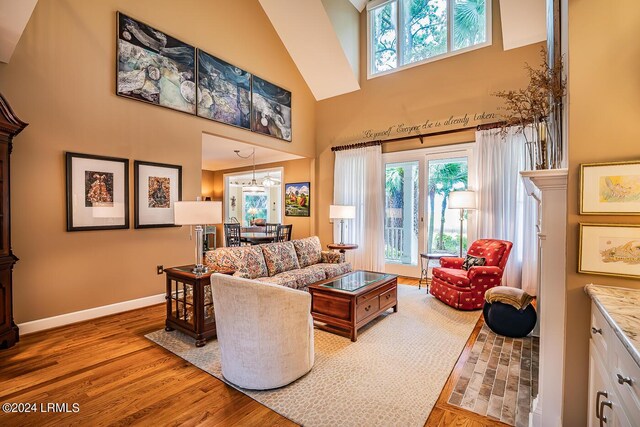 living room featuring hardwood / wood-style flooring and a towering ceiling