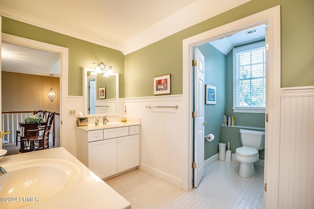 bathroom with vanity, lofted ceiling, tile patterned floors, and toilet