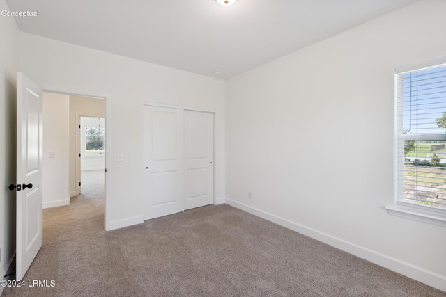 47 Silver St Unit 102, Ridgeland, SC 29936 - unfurnished bedroom featuring carpet floors, baseboards, and a closet