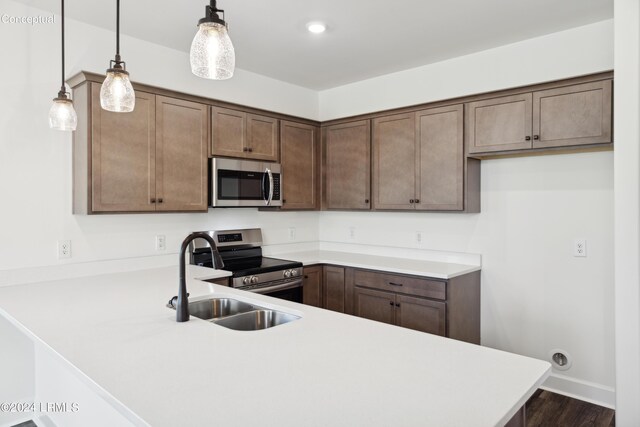 47 Silver St Unit 102, Ridgeland, SC 29936 - kitchen with stainless steel appliances, a peninsula, a sink, and light countertops