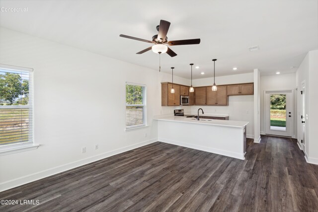 47 Silver St Unit 102, Ridgeland, SC 29936 - kitchen with appliances with stainless steel finishes, brown cabinets, dark wood-style flooring, a peninsula, and light countertops