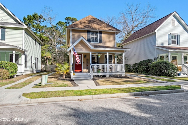 view of front of property with roof with shingles and a porch