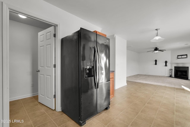 kitchen with ceiling fan and black refrigerator with ice dispenser