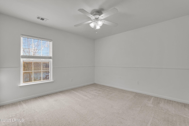 spare room featuring carpet and ceiling fan