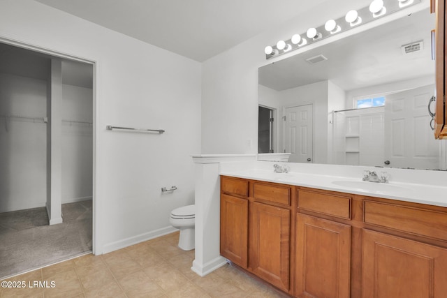 bathroom with vanity, toilet, and walk in shower