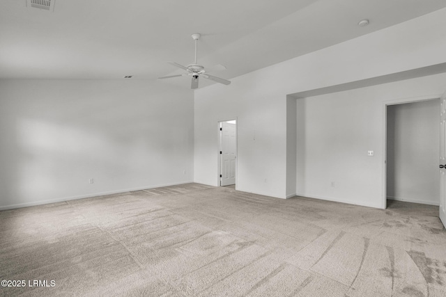 carpeted spare room featuring lofted ceiling and ceiling fan