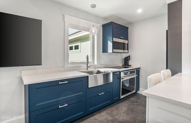 kitchen with appliances with stainless steel finishes, decorative light fixtures, blue cabinets, and sink