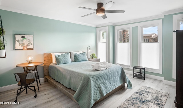 bedroom featuring multiple windows, crown molding, light hardwood / wood-style flooring, and ceiling fan