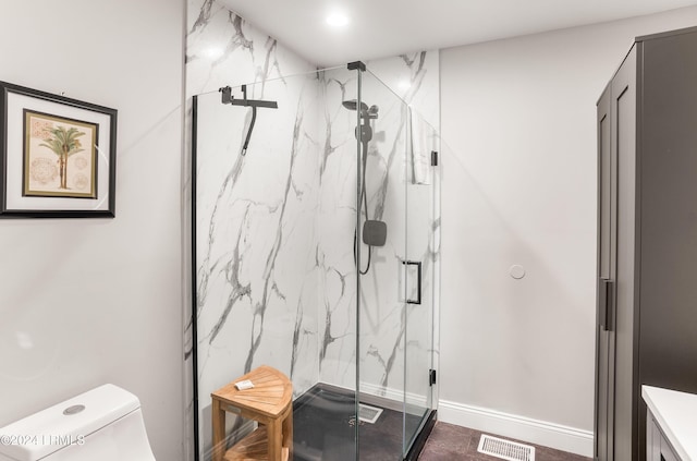 bathroom featuring an enclosed shower and toilet