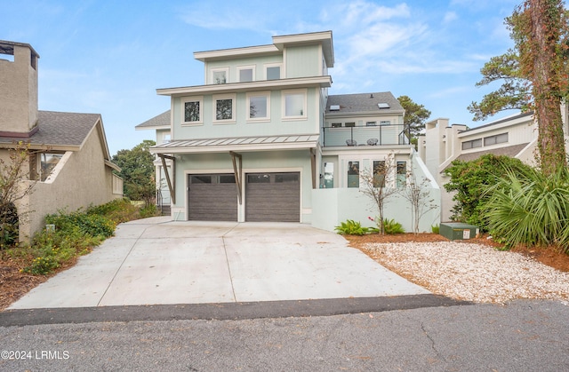 view of front facade with a garage and a balcony