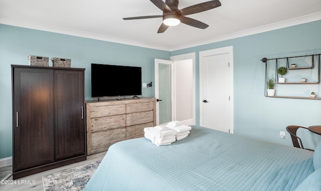 bedroom with crown molding, ceiling fan, and light wood-type flooring