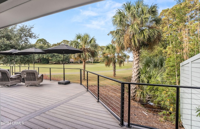 deck featuring a lawn and outdoor lounge area