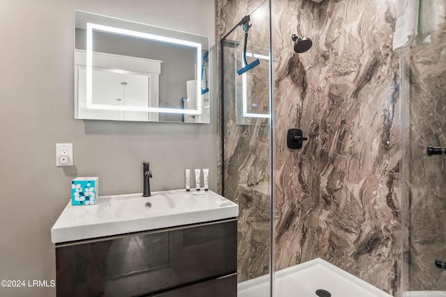 bathroom with vanity and tiled shower