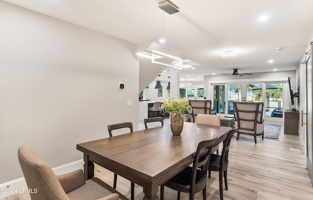 dining area with ceiling fan and light wood-type flooring