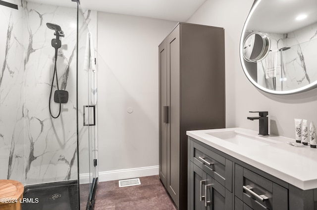 bathroom with vanity and a shower with shower door