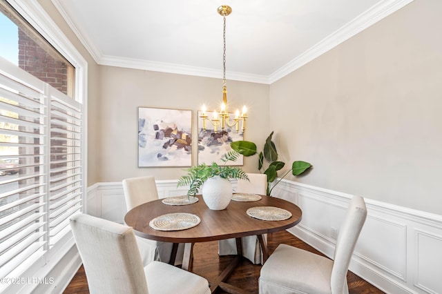 dining area with a wainscoted wall, a chandelier, dark wood finished floors, and crown molding