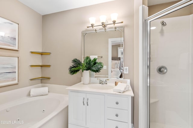 bathroom with ensuite bathroom, a shower stall, a tub with jets, and vanity